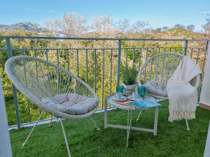two chairs and a table on a balcony at Elis rooms & suite in Olbia