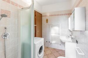 a bathroom with a washing machine and a sink at TINA HOME LAKE VIEW in Garda +44 photos