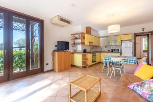 a kitchen and living room with a couch and a table at TINA HOME LAKE VIEW in Garda