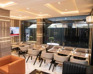 a restaurant with tables and chairs in a room at Orchid - Bliss Hotels in Lagos