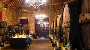 a large room with a table in a wine cellar at HI Douro Alijó - Pousada de Juventude in Alijó