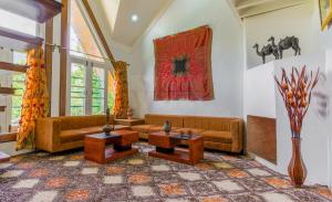 a living room with two couches and a table at Gaash Cottages in Buna Palang +1 photo