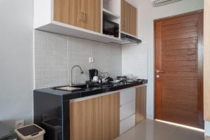 a kitchen with a sink and a counter top at Patera Living in Sempidi