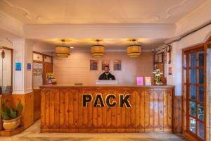 a man standing at a bar in a restaurant at Kalra Regency Shimla in Shimla