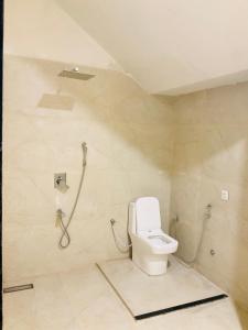 a bathroom with a toilet and a shower at Origin Suites Luxury Boutique Hotel Pushkar in Pushkar