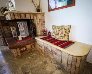a living room with a couch and a fireplace at Charming Country House Just Steps from Everything in Kyparissia