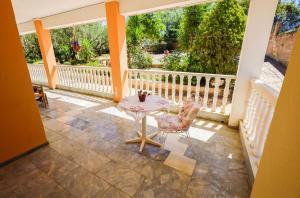 a patio with a table and a chair on a balcony at Charming Country House Just Steps from Everything in Kyparissia +49 photos