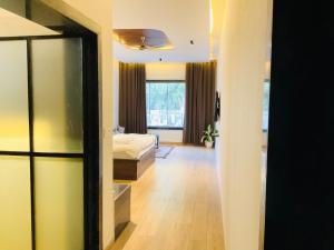 a bedroom with a bed and a room with a window at Origin Suites Luxury Boutique Hotel Pushkar in Pushkar