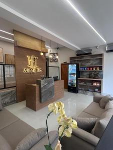 a living room with a couch and a television at Hotel Almeida in Montes Claros