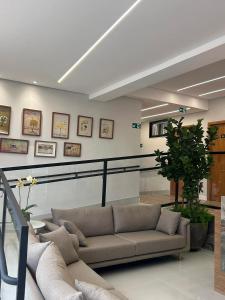 a living room with a couch in a room at Hotel Almeida in Montes Claros