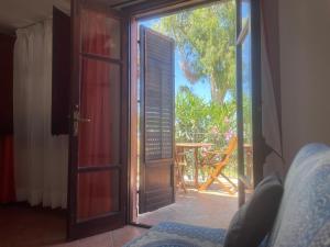 a door open to a patio with a view of a yard at Villa Magarà in Cefalù +206 photos
