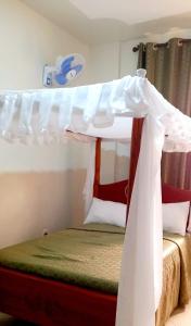 a bedroom with a bed with a canopy at summeroasishotet in Kitui