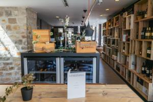 a wine shop with a table in the middle of a room at VENEZIANA Boutique Hotel Superior in Koper