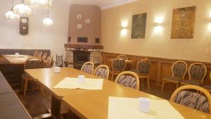 a restaurant with tables and chairs and a fireplace at Hotel Restaurant Krone in Bad Brückenau +1 photo
