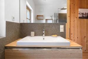 a bathroom with a white sink and a mirror at Ferienhaus Schwarzenbach in San Genesio Atesino +33 photos