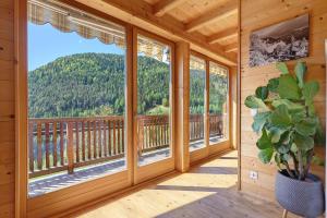 a room with windows with a view of a mountain at Ferienhaus Schwarzenbach in San Genesio Atesino