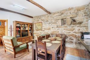 a kitchen and dining room with a table and chairs at Casa da Adega in Sá