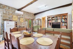 a kitchen and dining room with a wooden table at Casa da Adega in Sá