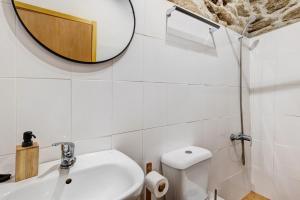 a bathroom with a mirror and a sink and a toilet at Casa da Adega in Sá +20 photos