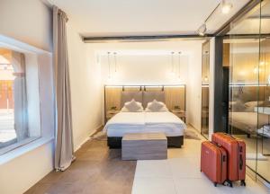 a hotel room with a bed and a suitcase at VENEZIANA Boutique Hotel Superior in Koper +34 photos