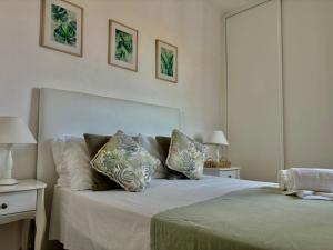 a bedroom with a large white bed with pillows at Al Mare Ocean View in Albufeira
