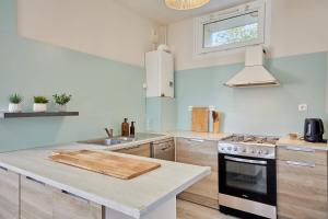 a kitchen with a chopping board on a counter at La Parenthese - Charme & Coeur Historique in Bayeux