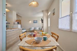 a kitchen and dining room with a table and chairs at La Parenthese - Charme & Coeur Historique in Bayeux +6 photos
