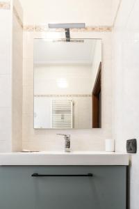 a bathroom with a sink and a mirror at A Due Passi dal Mare in Chioggia