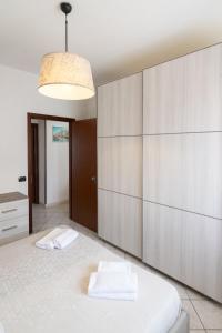 a bedroom with a bed and a large wall at A Due Passi dal Mare in Chioggia