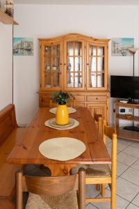 a kitchen with a wooden table with a yellow vase on it at A Due Passi dal Mare in Chioggia