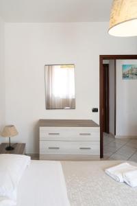 a bedroom with a dresser with a mirror on it at A Due Passi dal Mare in Chioggia +27 photos