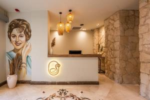 a lobby with a painting of a woman on the wall at Sam's Story Boutique Hotel in Cairo +89 photos