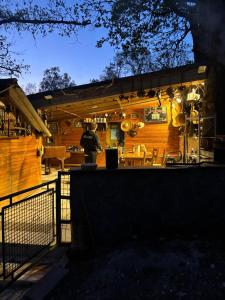 a porch of a wooden house with a fence at Chalet de la vallée in Souppes-sur-Loing