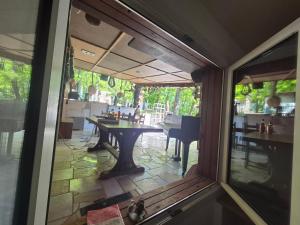 a view of a patio from the window of a restaurant at Chalet de la vallée in Souppes-sur-Loing