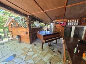 a kitchen with a piano on a patio at Chalet de la vallée in Souppes-sur-Loing +11 photos