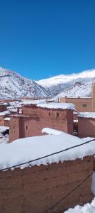 a group of buildings with snow on the roofs at Gite d'étape Chez Brahim in El Kelaa des Mgouna