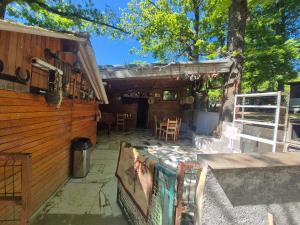 a porch of a house with chairs and tables at Chalet de la vallée in Souppes-sur-Loing