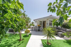 a garden with a patio and a house at Casa Caro in Estepona