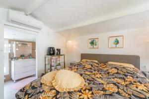 a bedroom with a bed and a bathroom with a sink at Casa Caro in Estepona