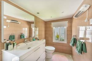 a bathroom with a white sink and a toilet at Casa Caro in Estepona +18 photos