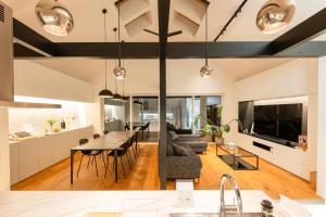 a kitchen and living room with a table and a couch at NAGASHIMA clas in Kuwana