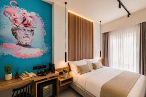 a bedroom with a bed and a painting of a head at The Q Hotel in Athens +57 photos