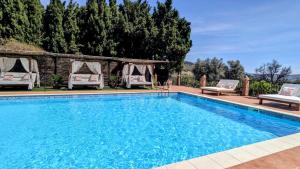 a swimming pool with two lounge chairs next to it at La Cañota 2-Floors King Rooms Adults Only in Talara