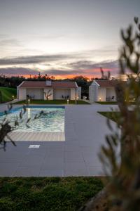 a view of a swimming pool with a house in the background at Casa do Santo Estevão in Macedo de Cavaleiros