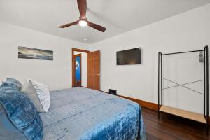 a bedroom with a bed and a ceiling fan at The Barker Bungalow in St. Charles