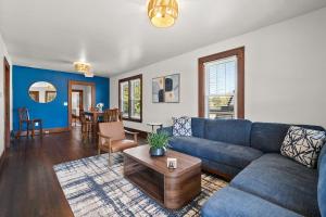 a living room with a blue couch and a table at The Barker Bungalow in St. Charles