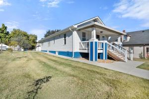 a white house with a porch and a yard at The Barker Bungalow in St. Charles