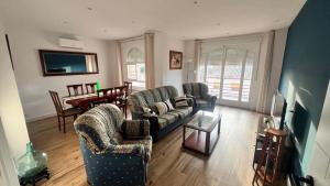 a living room with two couches and a dining room at Apartamento La Celestina in La Puebla de Montalbán