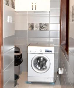 a washer and dryer in a small room at Dina Apartments in Kampala