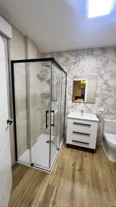 a bathroom with a shower and a sink at Apartamento La Celestina in La Puebla de Montalbán +2 photos